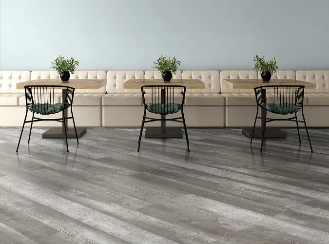 Cafe with long padded white bench seating and chairs flooring is a wood look resleint product