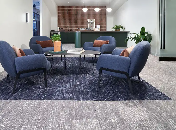 public space cafe area with blue and gray carpet tile flooring