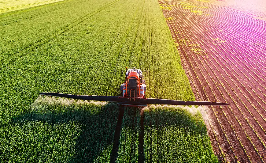 large Agriculture tractor spraying crops