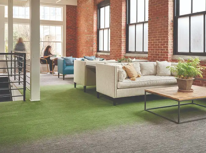 open public space with brick walls on green and grey hobre carpet