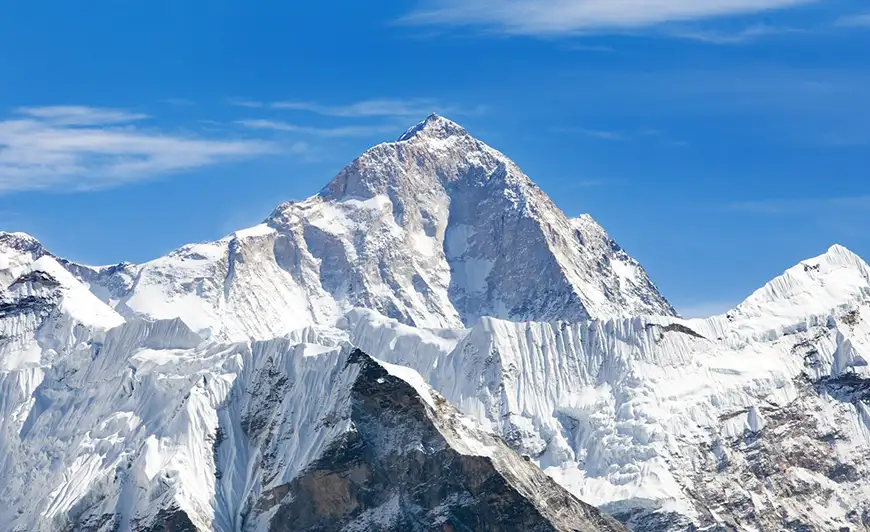 snow covered mountain surrounded by blue sky