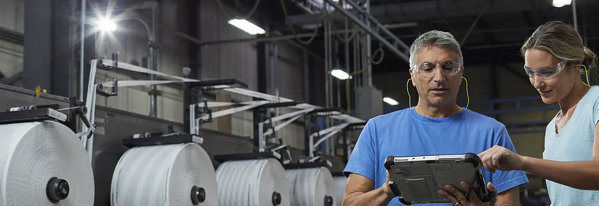 two people collaborating on manufacturing plant floor