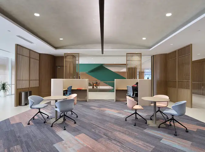 modern open workplace with wood finishes on plank carpet tile flooring