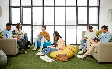 group of people in seating area with green carpet tile flooring