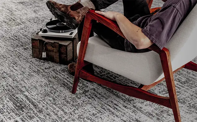 relaxed person sittig with turn table on the carpet flooring