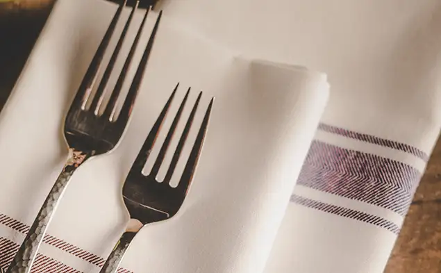 Close shot of forks on Milliken napery