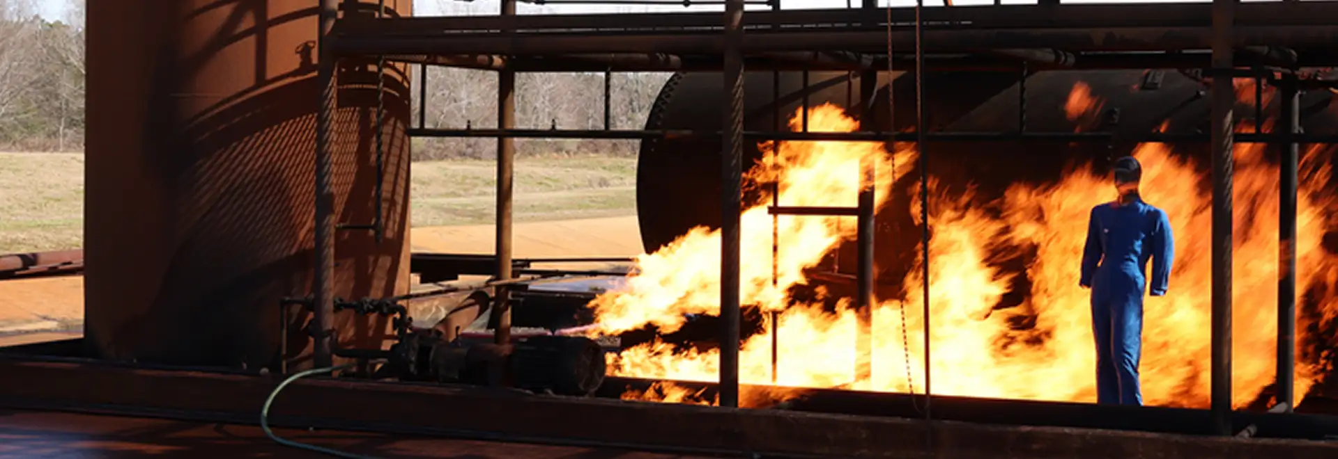 Flame resist fabric testing with dummy being exposed to flames