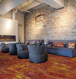 Seating area with brick wall and red carpet