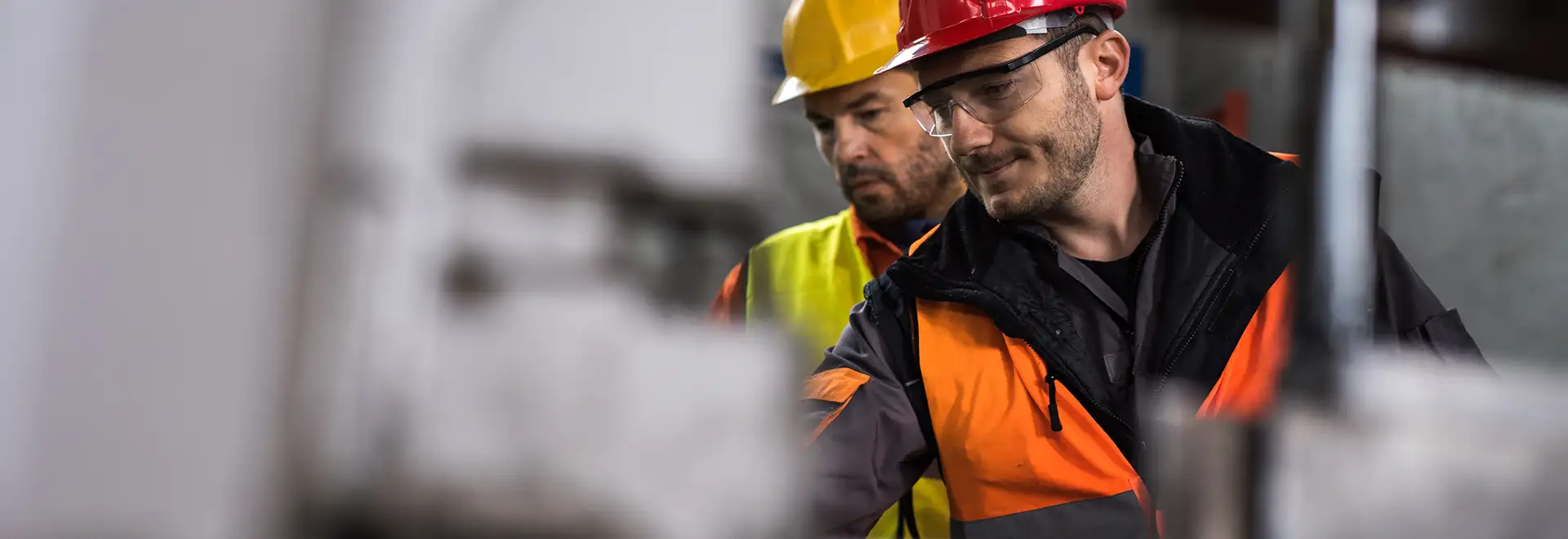 two men with hard hats working