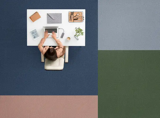 aerial view of a person at a desk on carpet tile from the Glass House carpet collection