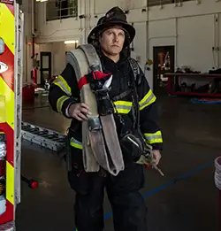 Firefighter in the station wearing Milliken Fire Service wear