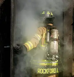 fire fighter going into a smoke filled building