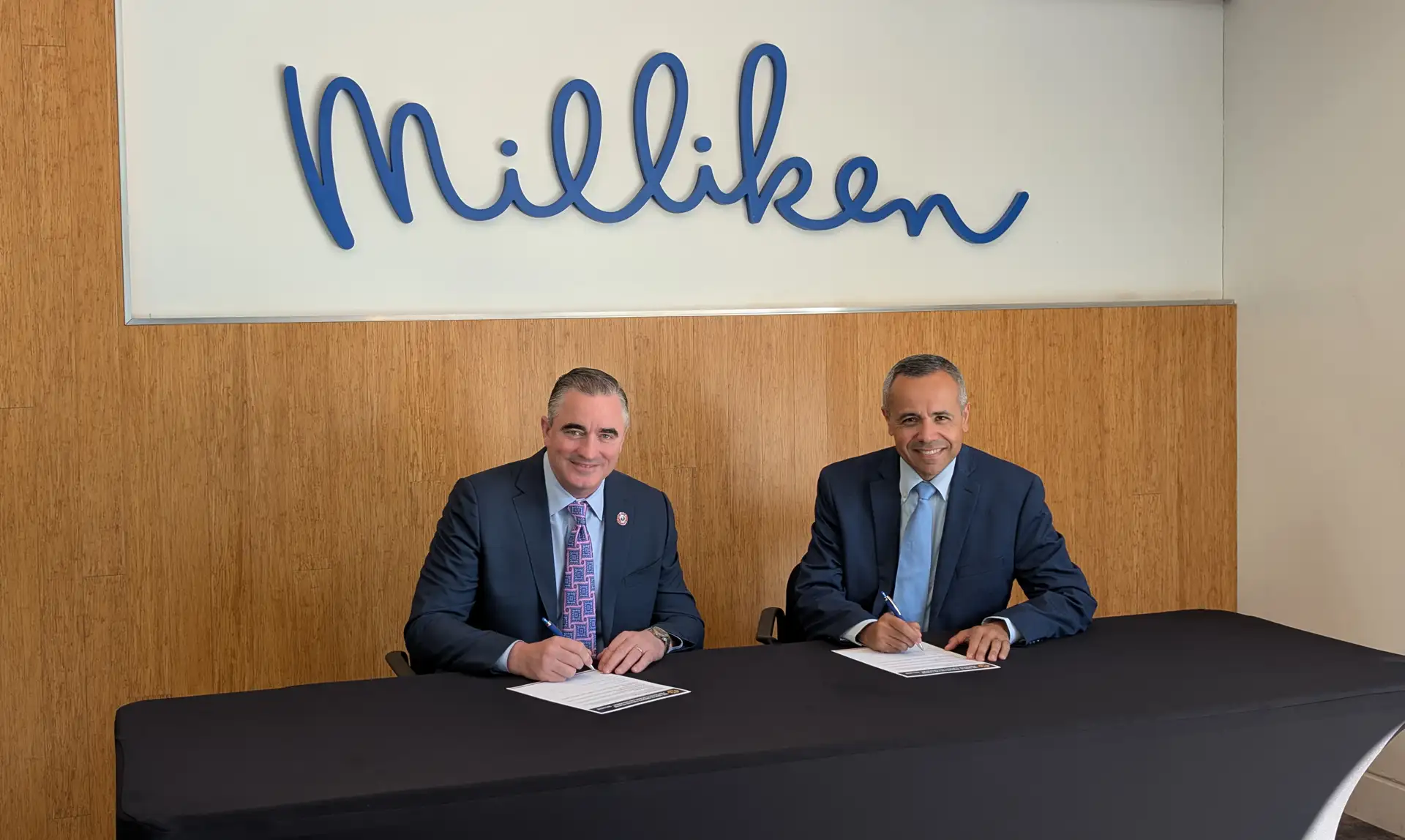 IAFF General President Edward Kelly and Milliken Apparel EVP Marcio Manique sign the IAFF Code of Conduct