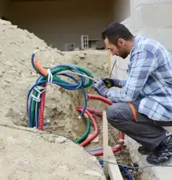 worker pulling communication wiring