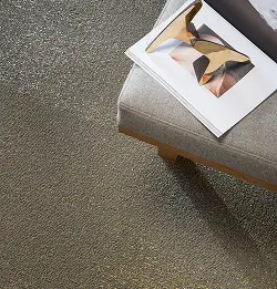 Close top down view of a seat corner with a book on it on neutral carpet tile