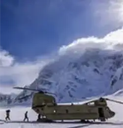 snowy landsaphe with helicopter and troups in Milliken Extreme cold weather apperal