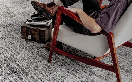 person sitting in chair on Milliken Carpet tile