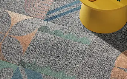 close up of yellow stool on large scale geometric carrpet tiles from the Pattern Play collection