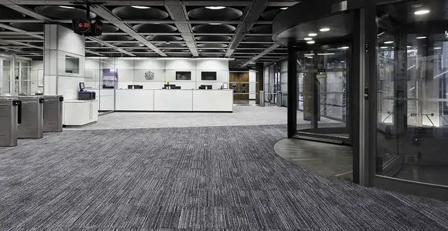 Educational entryway with inset flooring carpet tiles in gray colors