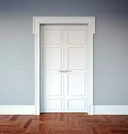 interior Architectural detail of a white door and trim with gray wallwith 