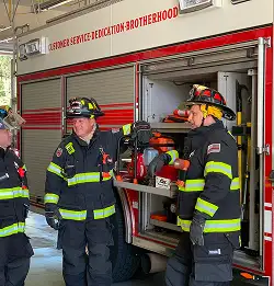 Fire fighters in station wearing turnout gear made with Milliken fabrics