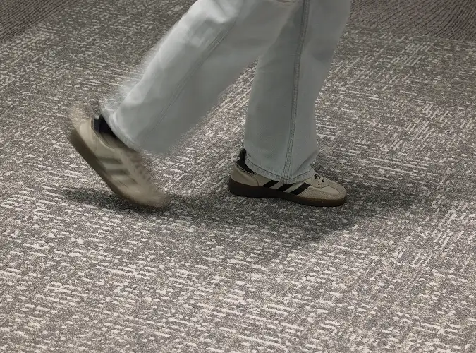 close up of person walking on textural flooring