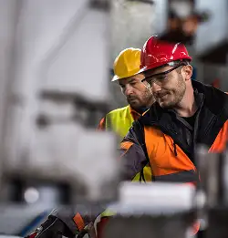 two workers with saftey glasses and hard hats
