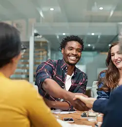 group of smiling assocaites collaborating