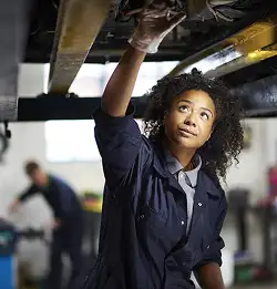 person working on a car wearing Milliken textiles
