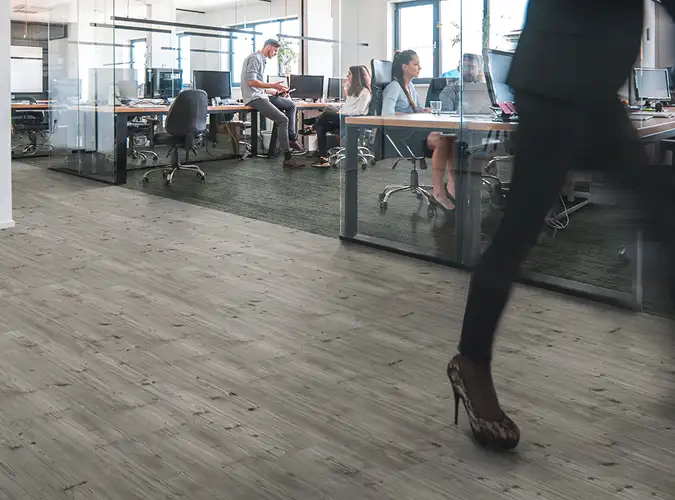 busy office with person walking on LVT flooring