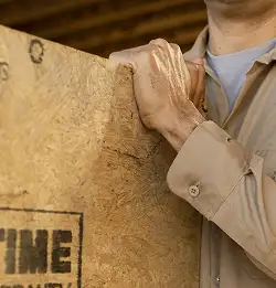 close shot of person holding plywood wearing Milliken soil release fabric