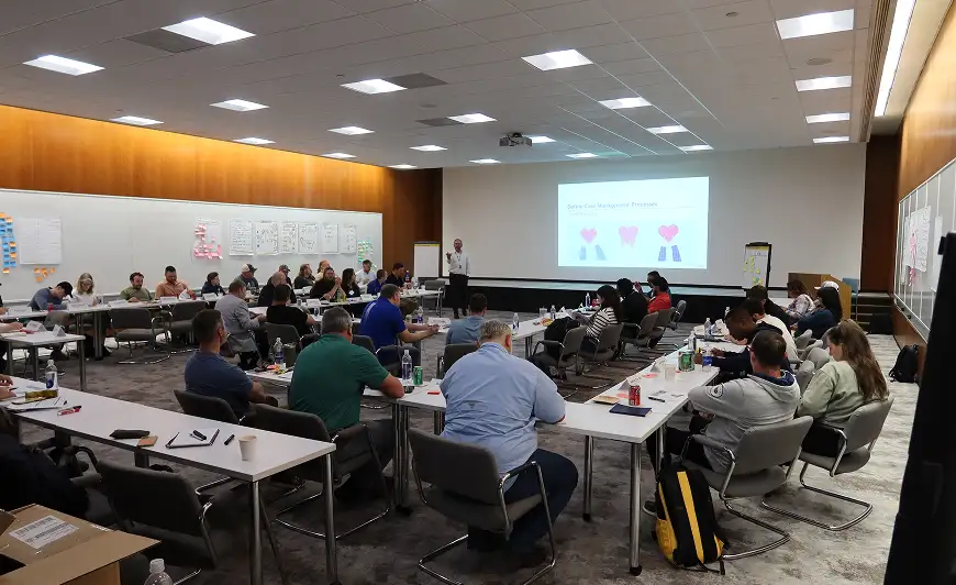 classroom setting with a large group of business people