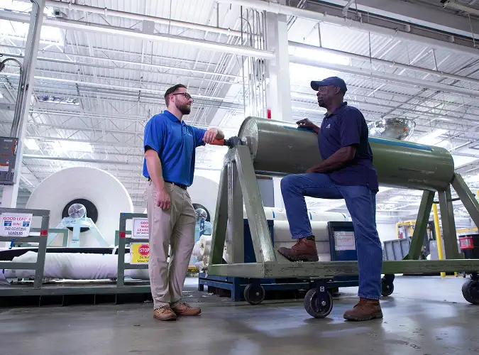 two people collaborating on manufacturing plant floor