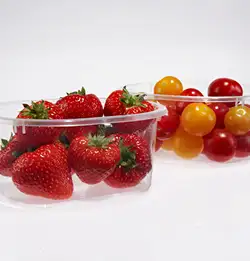two clear containers one with strawberries and the other with cherry tomatoes