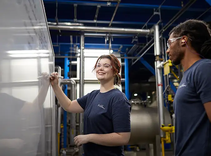 people talking and writing on white board