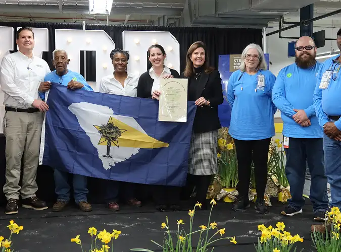 Happy people posing with OSAH award