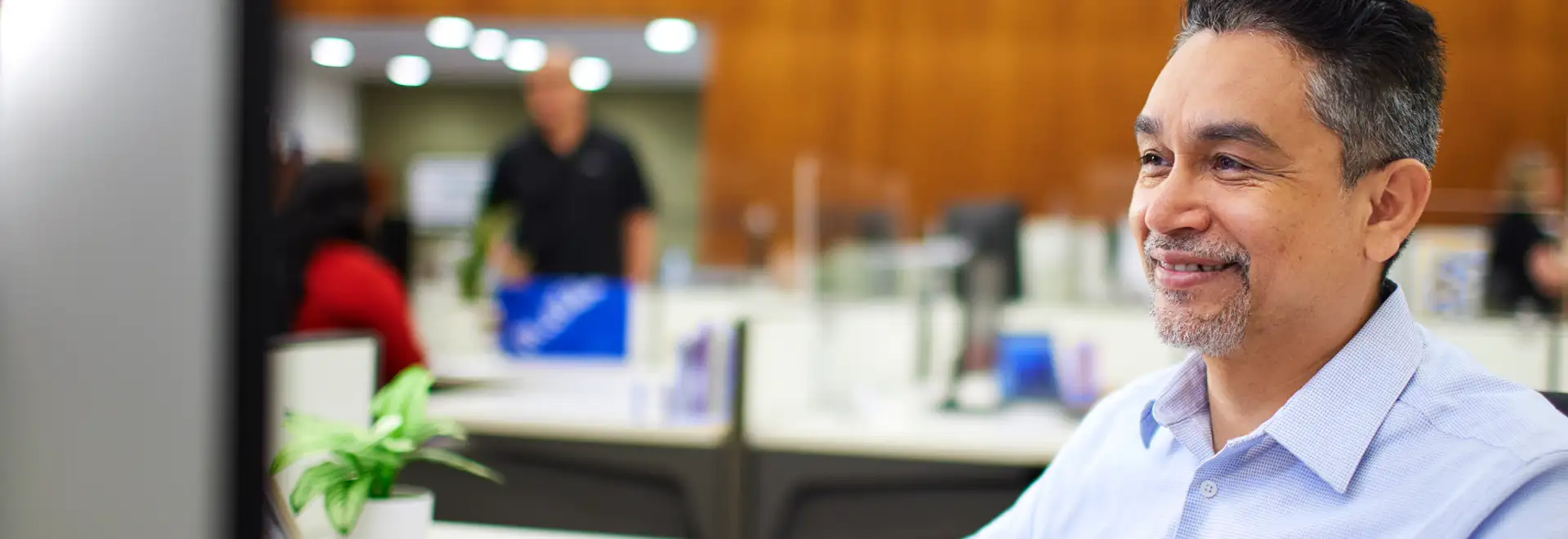 smiling associate looking at computer