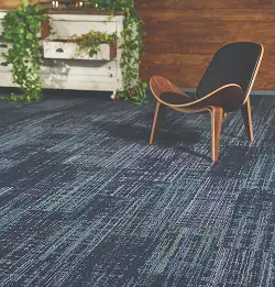 Chair on textural blue carpet tile
