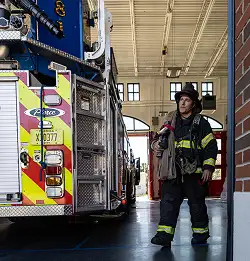 fire fighter in station wearing Milliken Turnout Gear