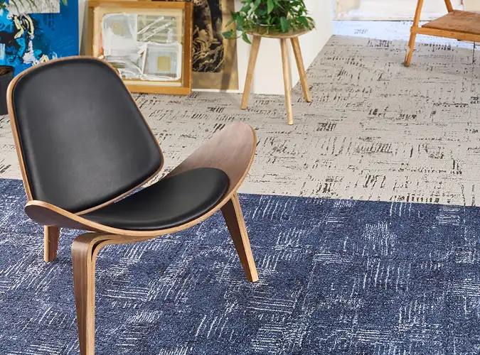 Chair on blue inset of carpet tile form the Open Studio collection