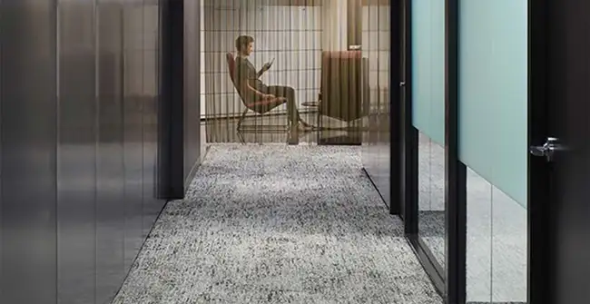 modern Workplace hallway with seated person at the end 