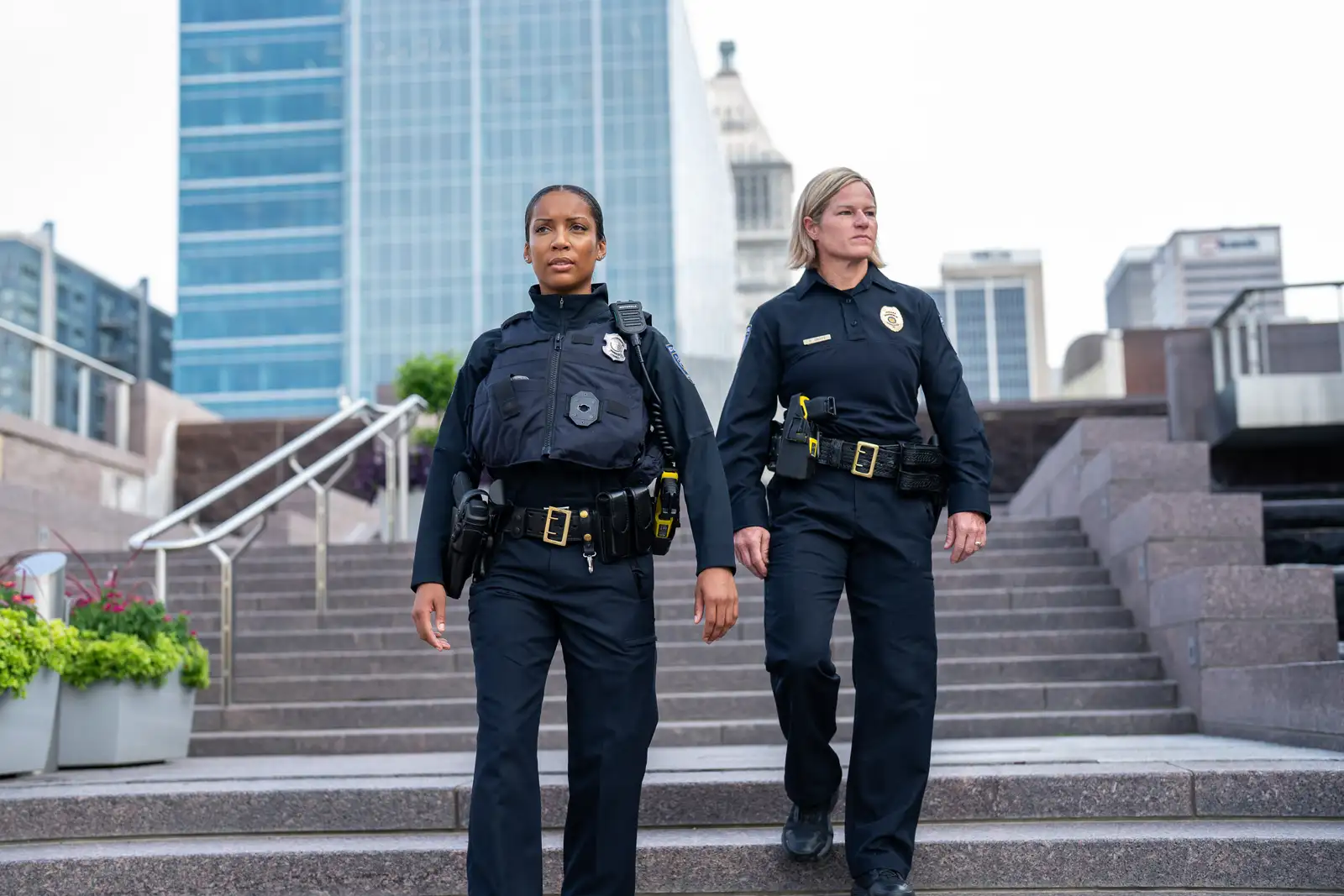 two police women wearing TitanFlex walking down stairs