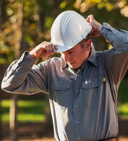 person putting on a hard hat