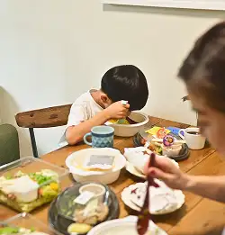 Family eating a table showing Milliken food and beverage packaging