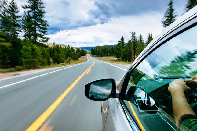view outside of a car widow showing a view of the road