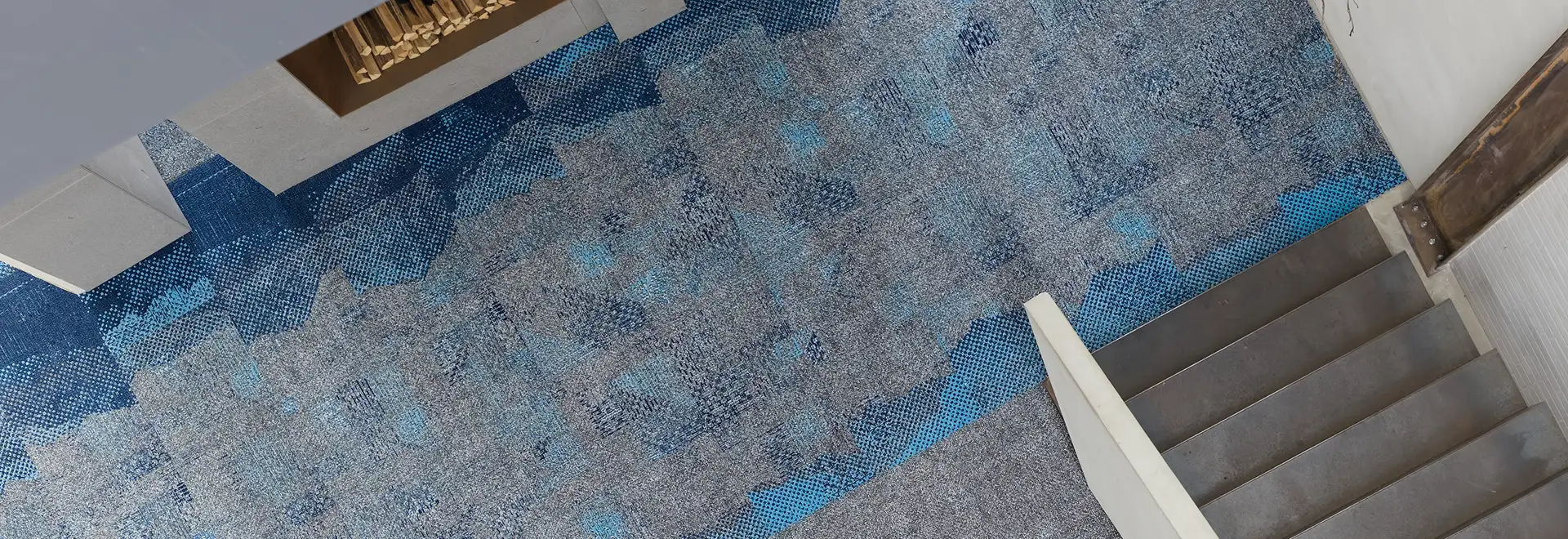 top down view of gray and blue Millken carpet with transitions