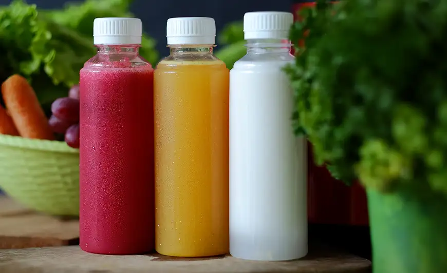 Clear bottles with colorful fruit juices