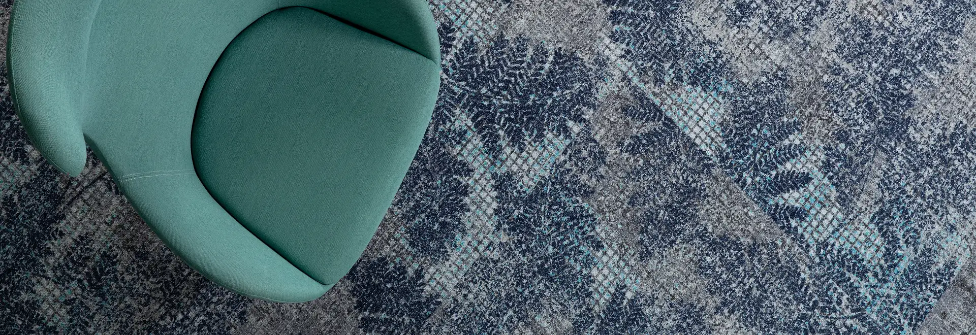 top down of a teal chair or organic pattern carpet tile floor