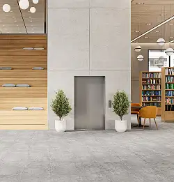 interior of an elevator with stairs to the left - flooring in textural gray carpet