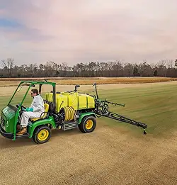 person on farm equipment spraying Evergreen Jade